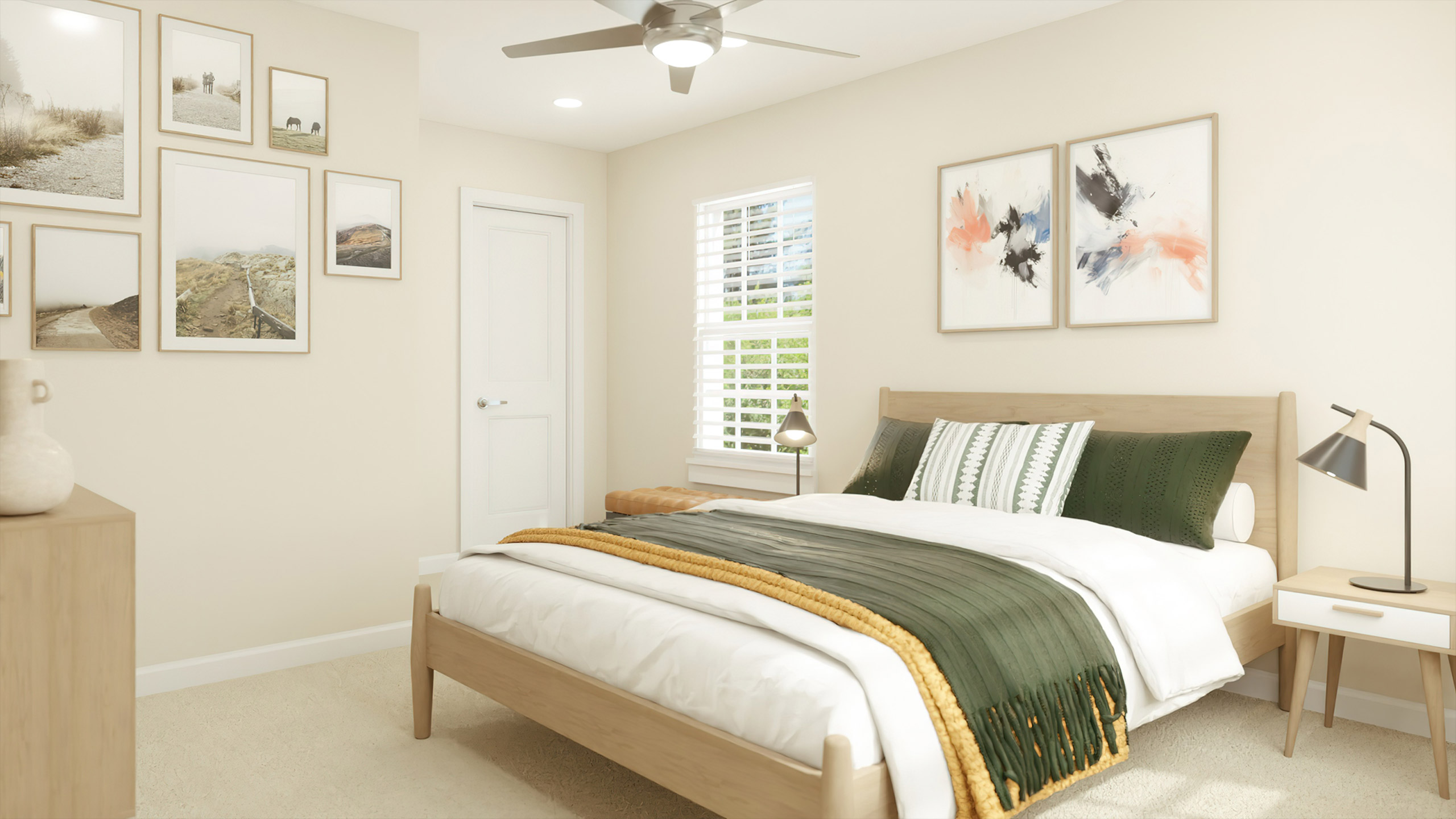 An interior view of a bedroom with a bed, two side tables with lamps, a front-end table, wall artwork, a ceiling fan, a bedroom window, and a closet door at Patrick's Pointe apartment homes for rent in Southern Pines, NC
